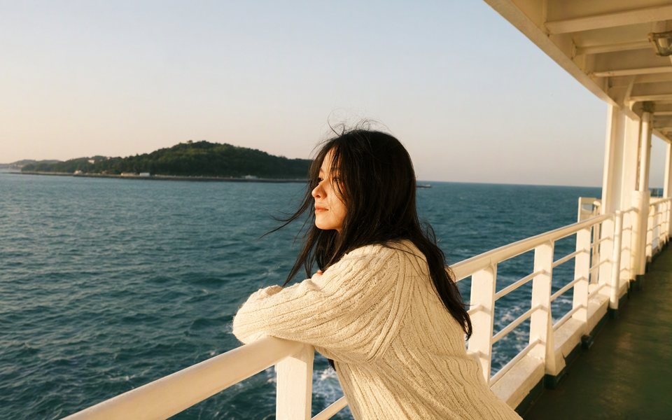 The ferry deck portrait extended to a wide picture with more railing, sea and coastline.